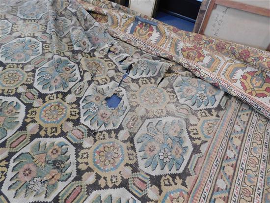 A large Indian carpet, circa 1910, 16ft 1in x 21ft 4in. (652cm x 491cm), fragment 5ft 11in. x 3ft 6in.